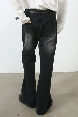 Dark wash flare jeans with distressed details and subtle stitch accents.