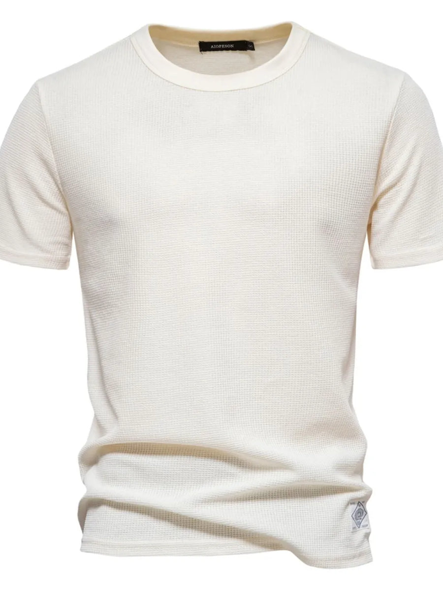 Ivory textured crew-neck t-shirt knit with short sleeves and a waffle knit pattern.