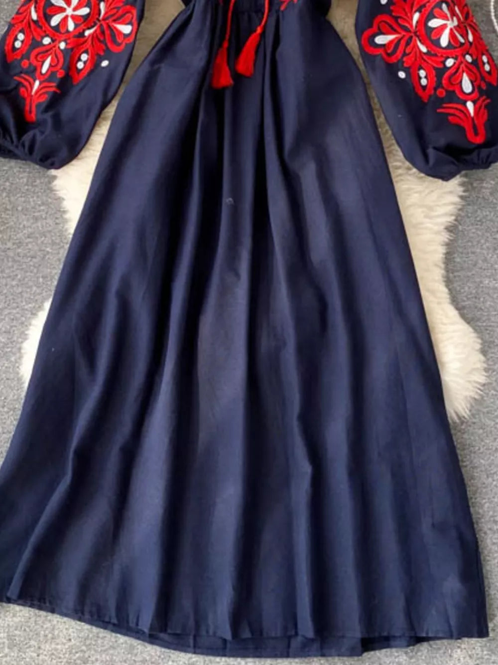 Navy maxi dress with embroidered balloon sleeves and red tassels