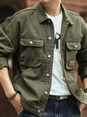 Moss green washed cotton chore jacket with four utility pockets and button closure.