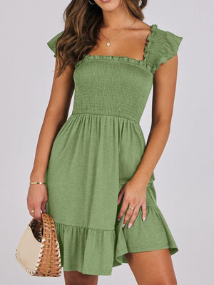 Sage green smocked ruffle hem mini dress with square neckline and flutter sleeves.