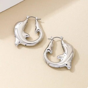 Silver dolphin hoop earrings with a sleek, polished finish.