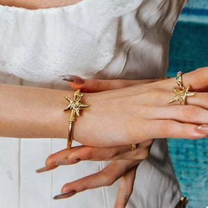 bracelet in gold featuring starfish charm and open fit
