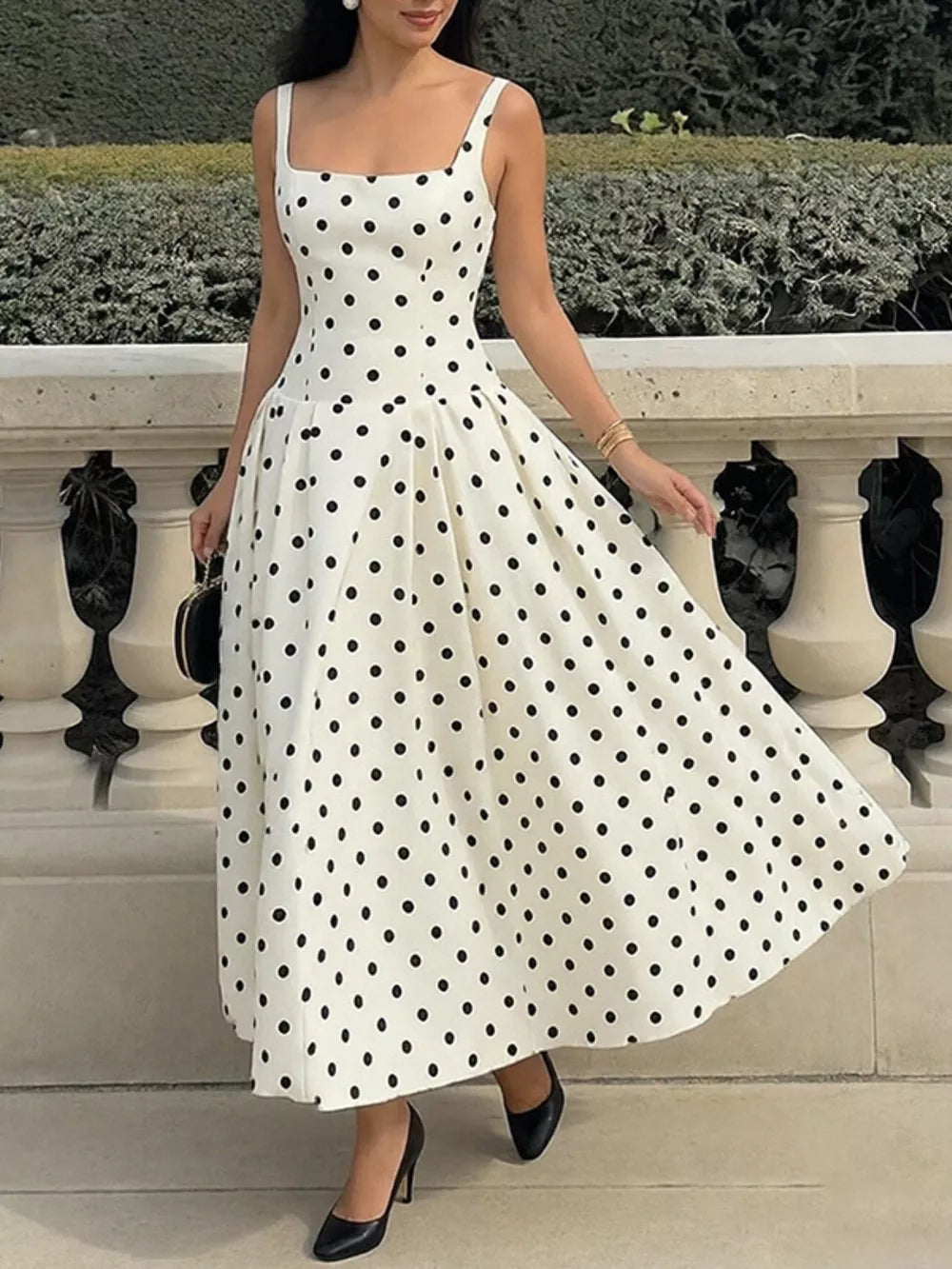 White polka dot A-line maxi dress with square neckline and flared skirt.