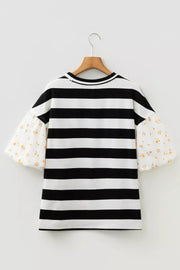 Maternity t-shirt with black and white stripes and floral puff sleeves.