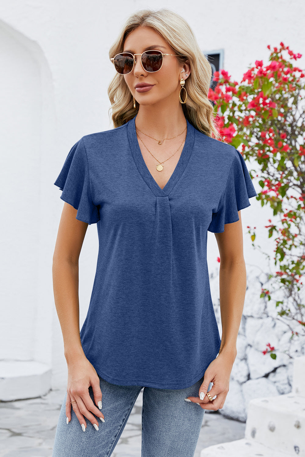 Dark blue V-neck blouse with pleated front and flutter sleeves.