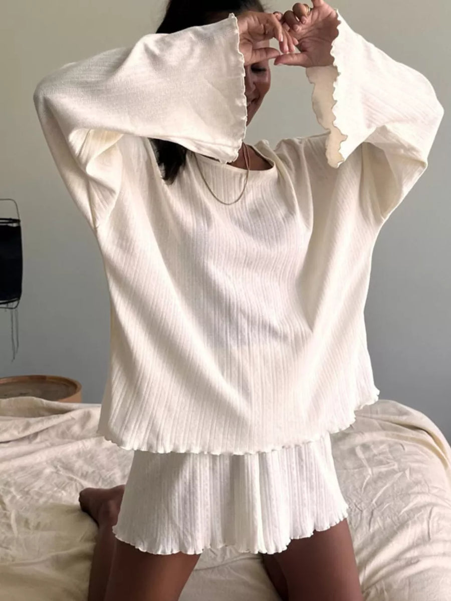 Cozy ribbed knit lounge set in cream with bell sleeves and lettuce trim hem.