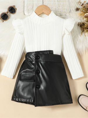 White ribbed knit top with ruffled sleeves and black faux leather skirt with button detail.