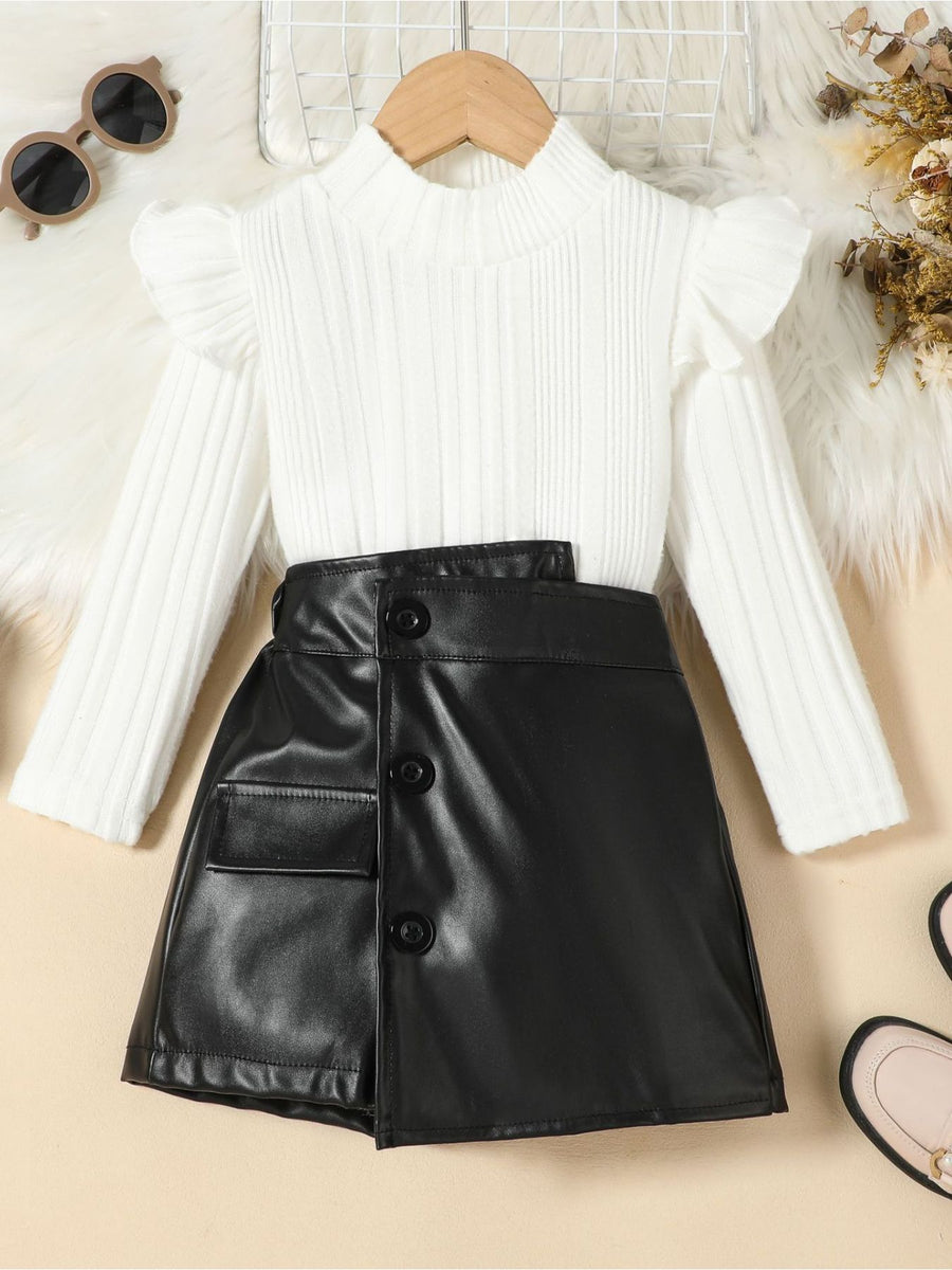 White ribbed knit top with ruffled sleeves and black faux leather skirt with button detail.