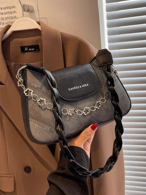 Textured black shoulder bag with braided strap and decorative chain strap detail