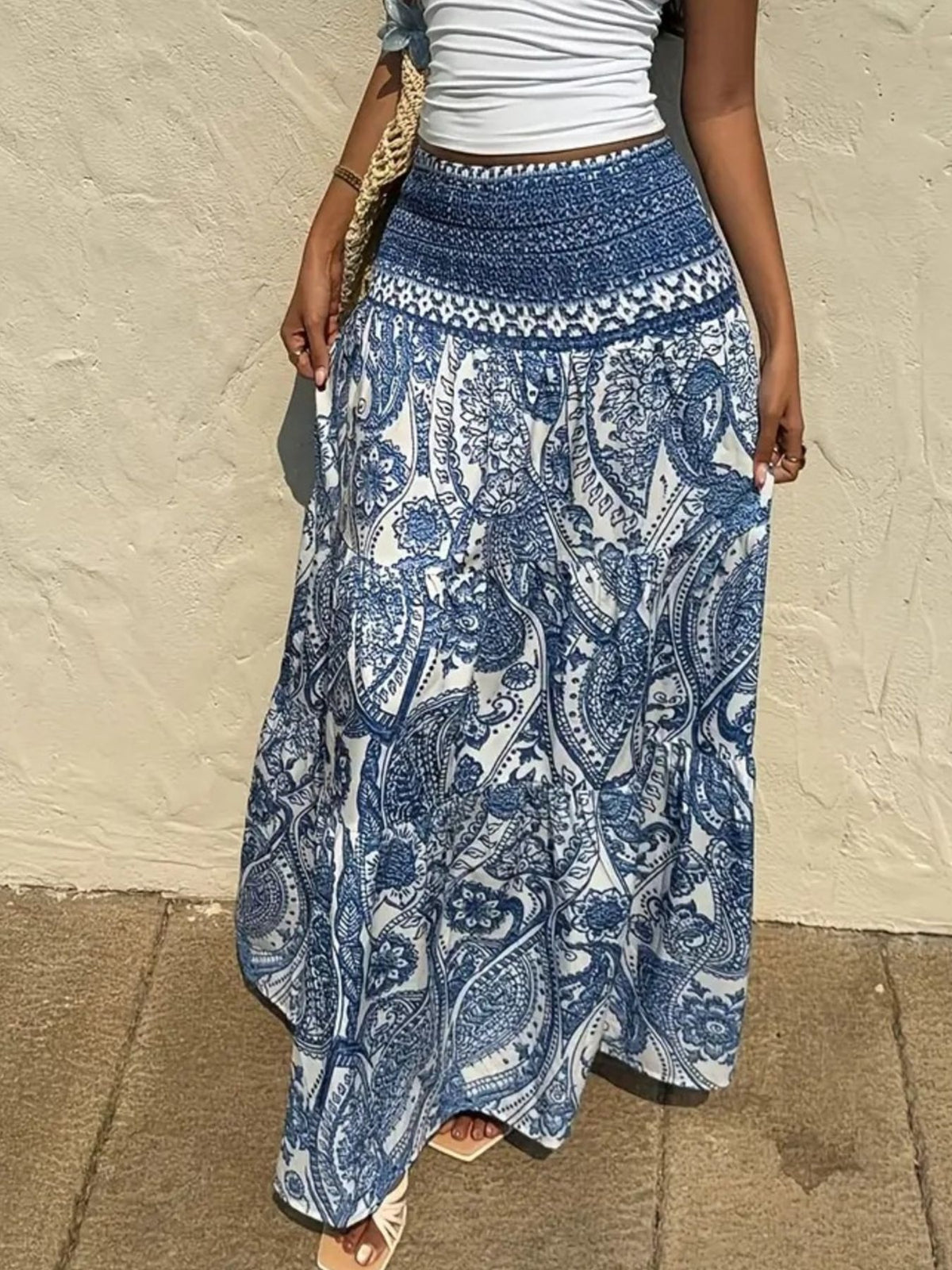 Bohemian paisley maxi skirt in blue with a smocked waistband and tiered flowy hem.