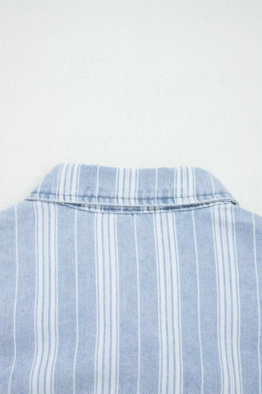 Relaxed denim shacket with blue and white vertical stripes and a collar detail.