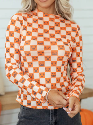 orange blouse with checked and mock neck