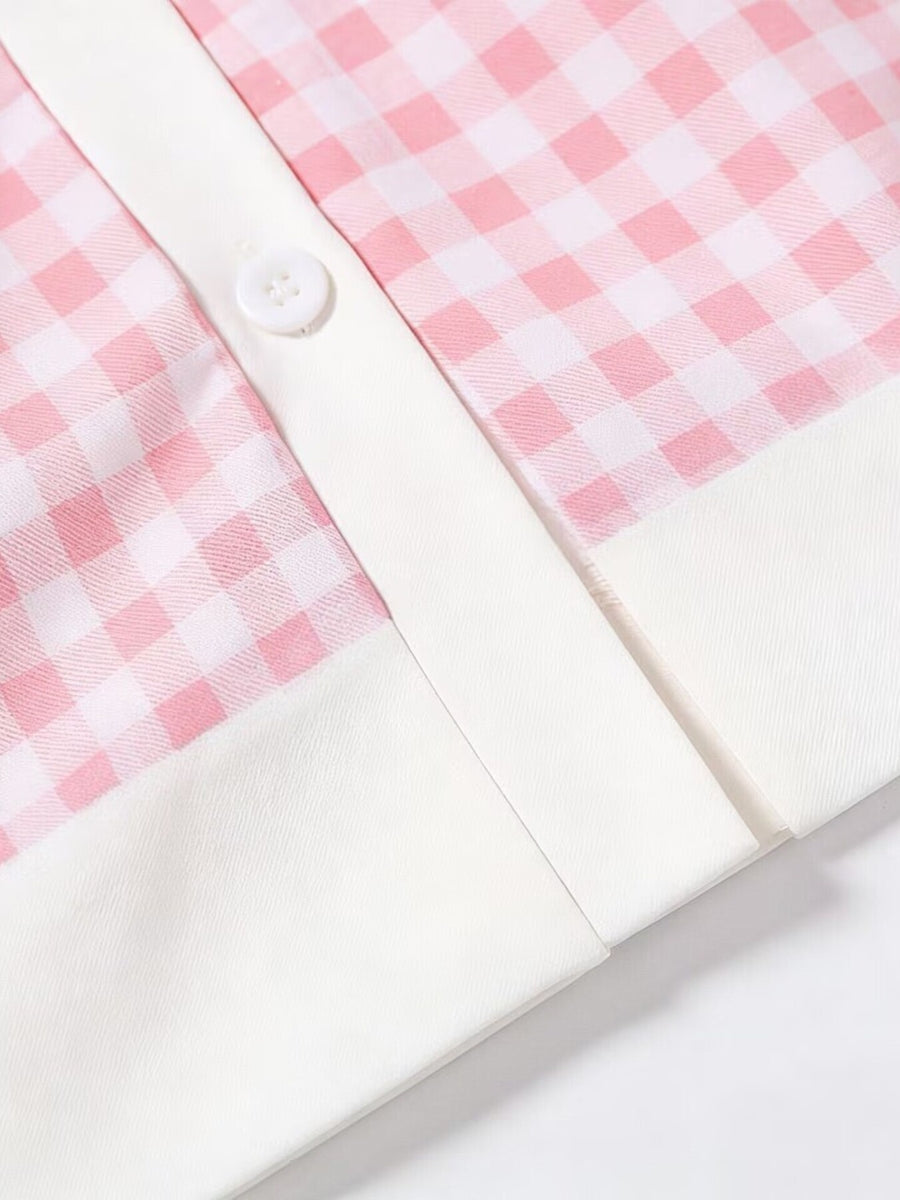 Pink gingham toddler dress with white trim and button detail.