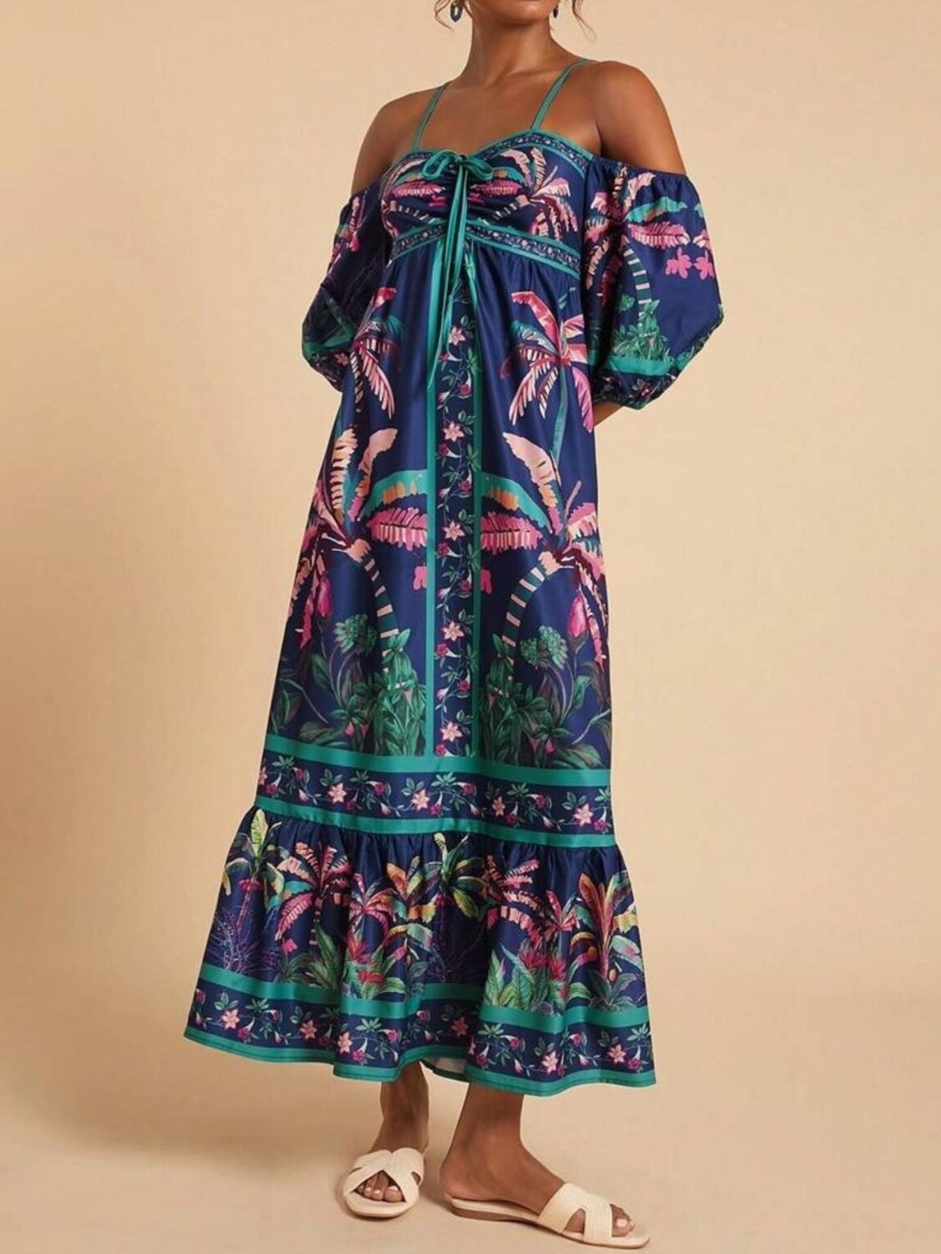 Maxi dress with tropical print, smocked bodice, tie front, and off-shoulder sleeves.