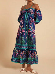 Maxi dress with tropical print, smocked bodice, tie front, and off-shoulder sleeves.