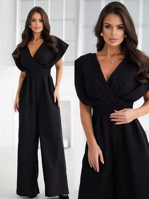 Black surplice wide-leg romper with flutter sleeves and a deep V-neck.