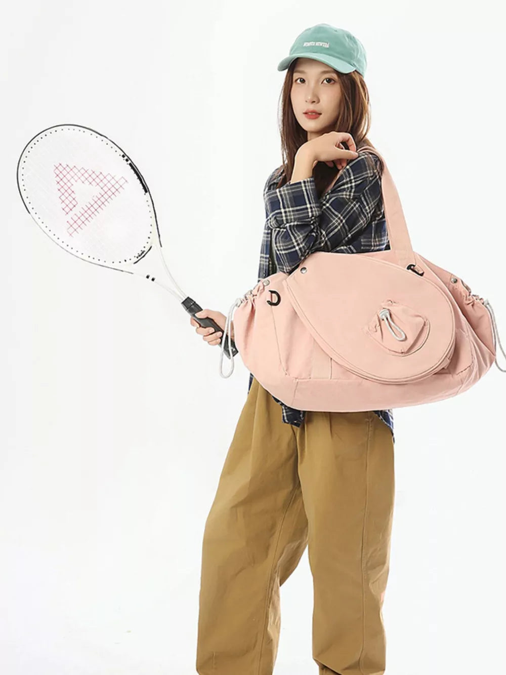 Pink athletic nylon tote with racket holder and cinch cord detail.