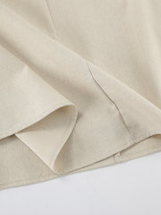 Beige smocked tube dress detail showing cotton fabric and a-line cut.