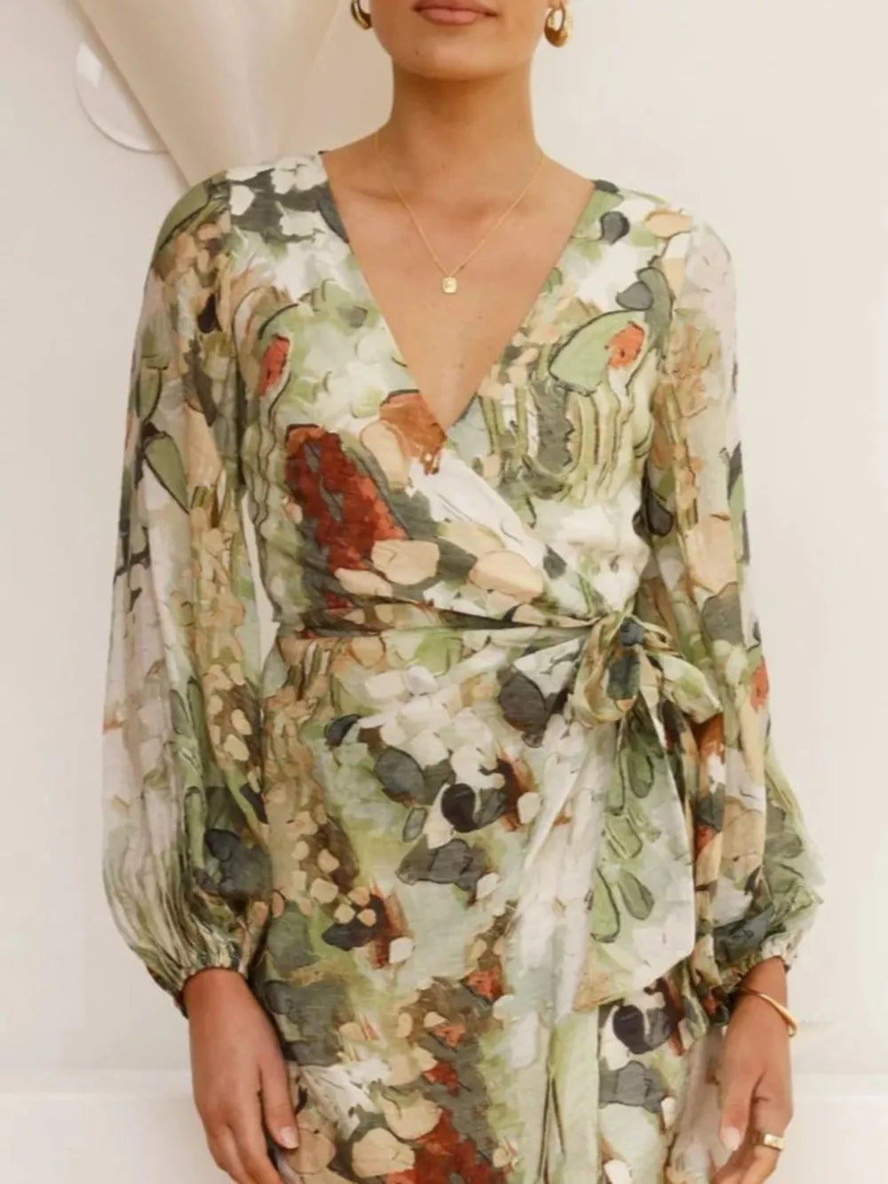 V-neck tie waist dress with abstract green and brown print, balloon sleeves.