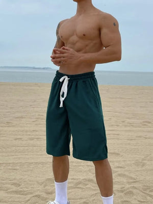 Dark Green relaxed-fit drawstring bermuda shorts with white tie detail.