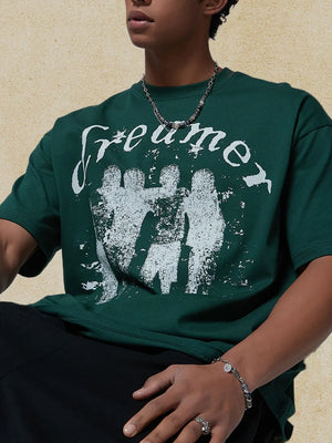 Dark green oversized tee with white graphic print and text.