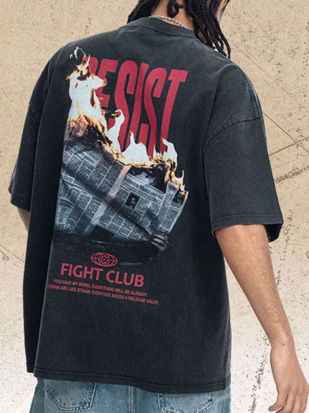 Distressed charcoal graphic tee with "RESIST" and burning newspaper print.