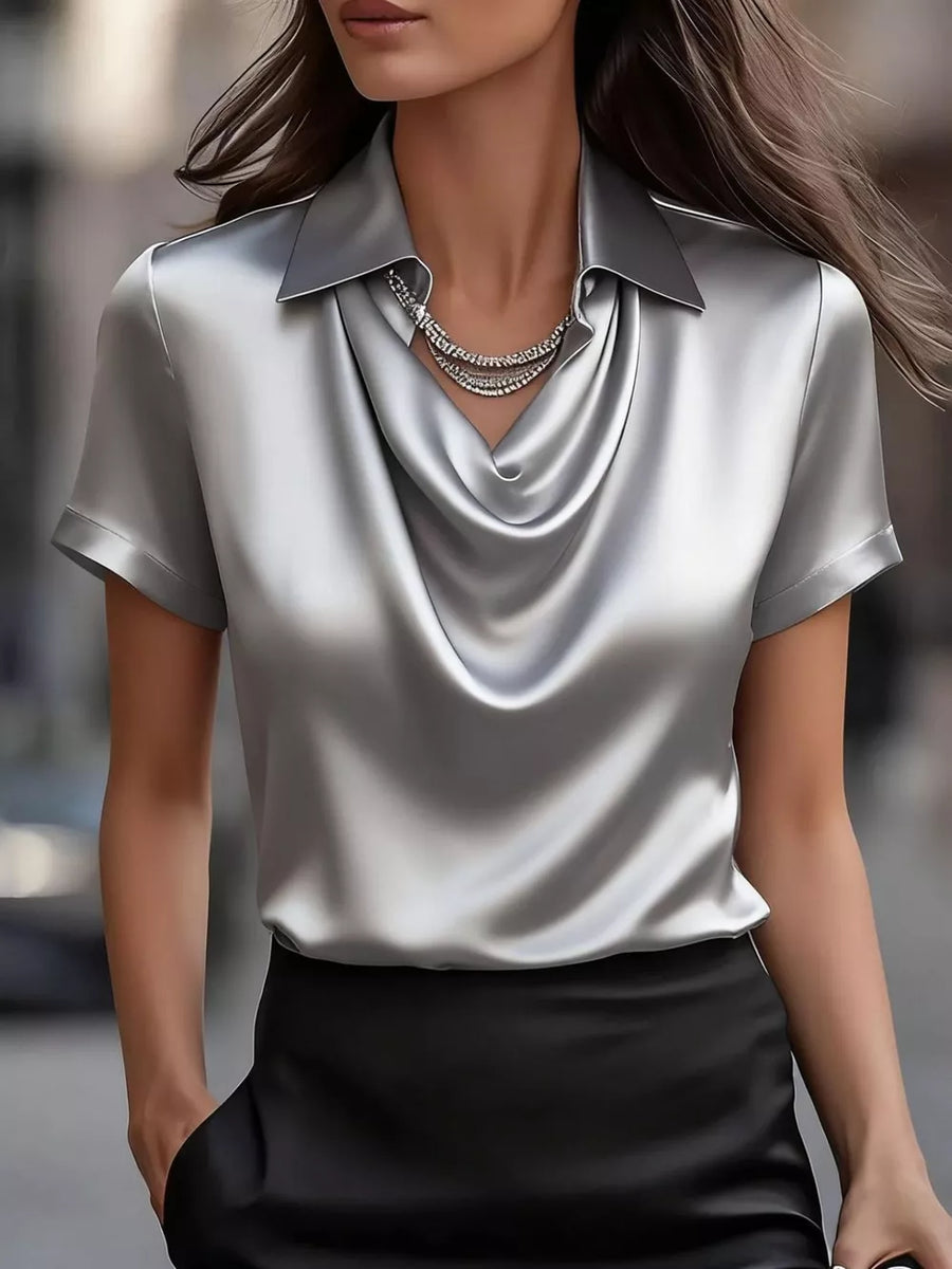 Grey satin cowl neck shirt with short sleeves and a collared neckline.