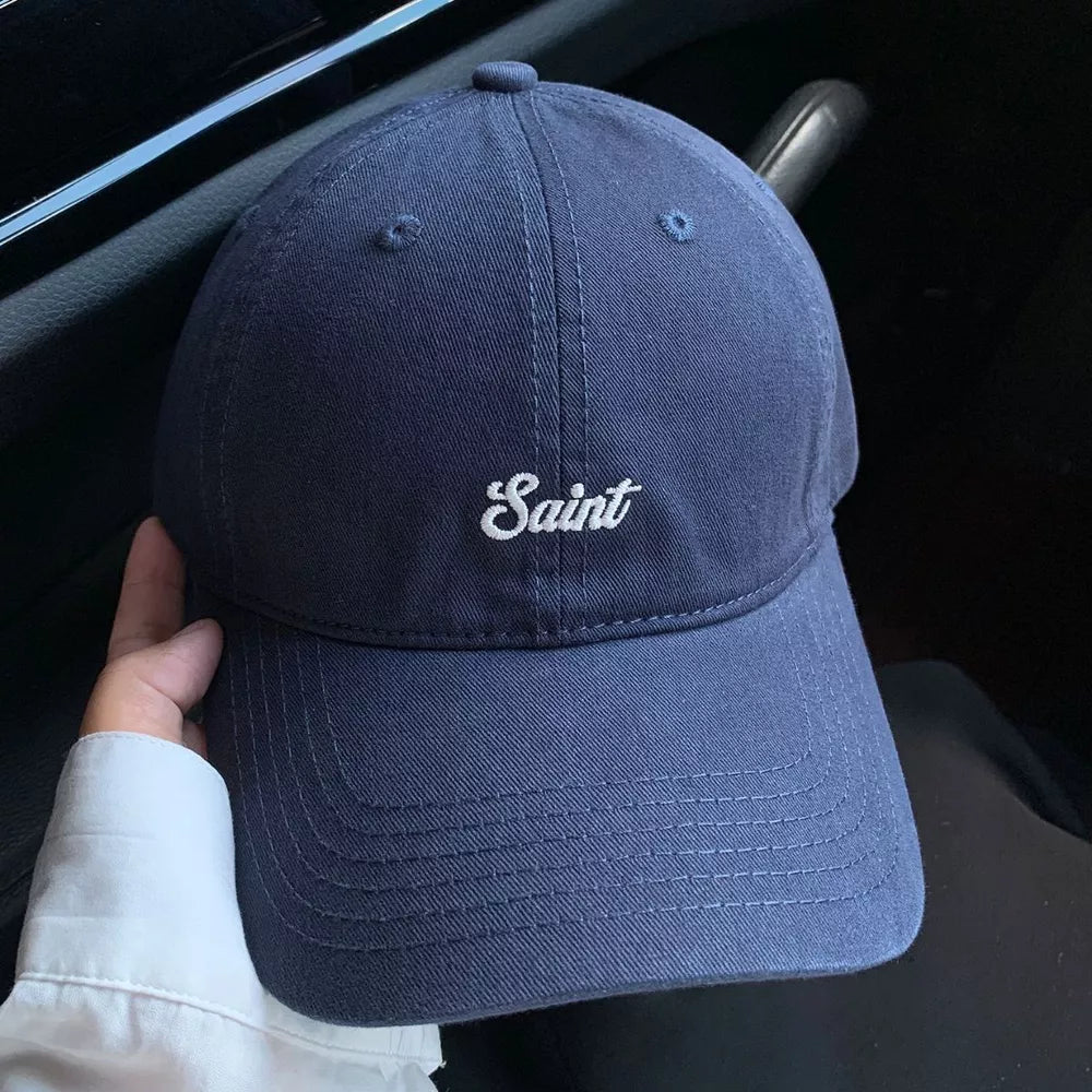 Navy blue cotton baseball cap with white script embroidery