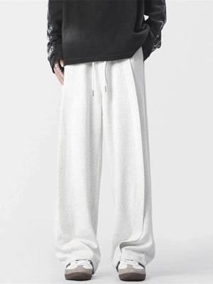 Men's light grey loose fit drawstring joggers with stitched seams
