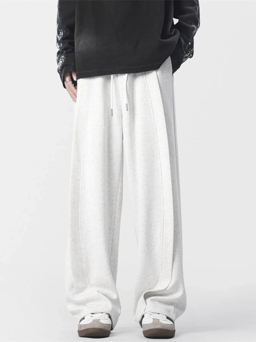 Men's light grey loose fit drawstring joggers with stitched seams