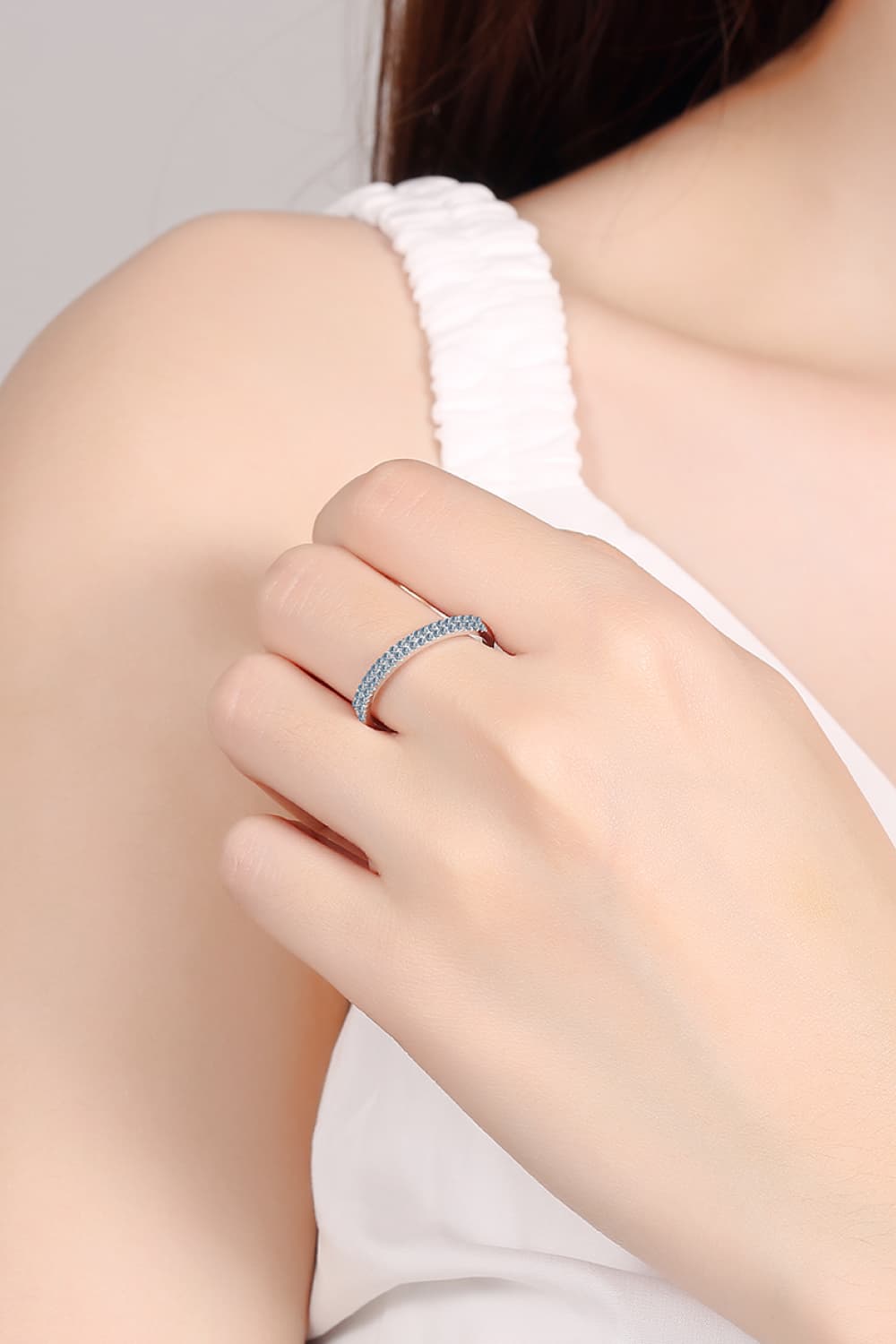 Pavé band sterling silver ring with small stones on a woman's finger
