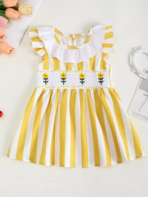 Yellow and white striped baby dress with smocked floral bodice and ruffle collar.