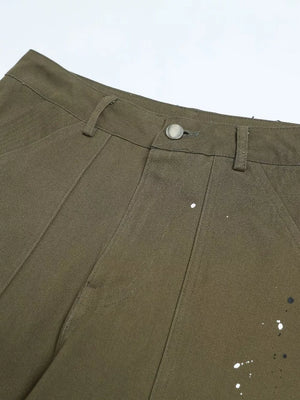 Olive green cotton cargo pants with white and black paint splatter detail and button fly.