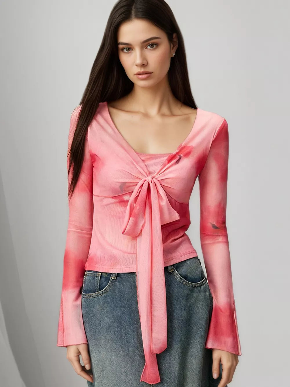 Pink watercolor tie-front t-shirt with flared sleeves and a V-neck.