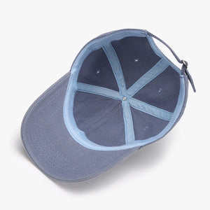 Textured denim baseball cap in Dusty Blue, showing interior construction and adjustable strap.
