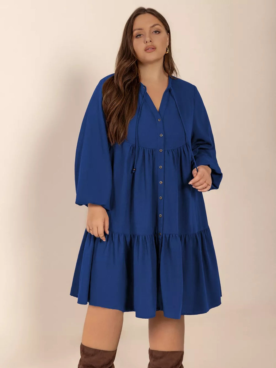 Plus-size dark blue a-line dress with tie-neck and button-front detail