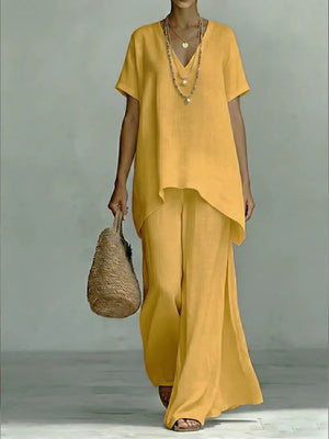 Yellow linen V-neck short sleeve tunic and wide leg pants set with layered necklaces.