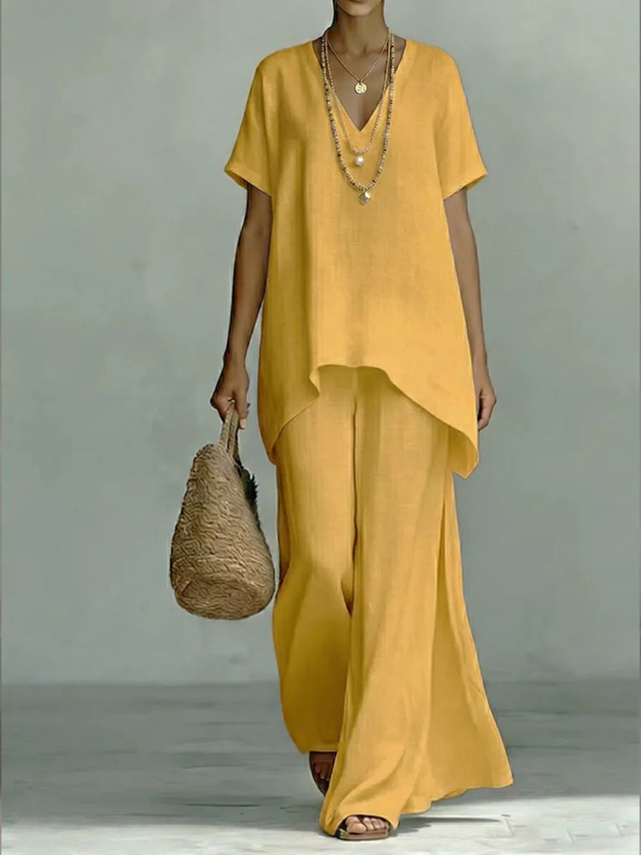 Yellow linen V-neck short sleeve tunic and wide leg pants set with layered necklaces.
