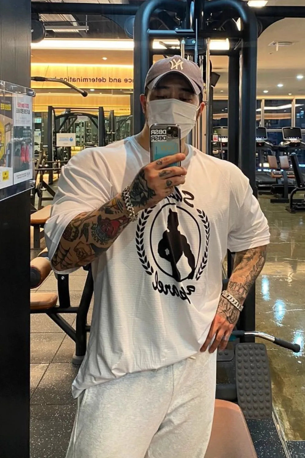 White oversized graphic tee with crew neck and short sleeves, featuring a black athletic silhouette logo.