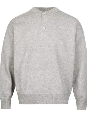 Light gray knit sweater with button detail and drop shoulders