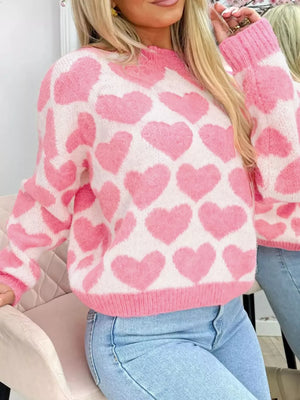 Charming heart pattern knit sweater in blush pink acrylic with a crew neck and long sleeves.