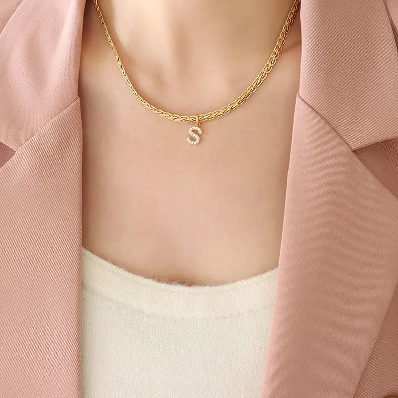 Gold textured chain necklace with a crystal initial S charm