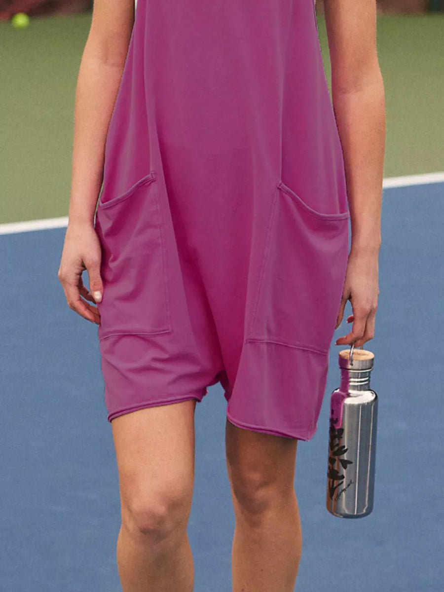 Purple sleeveless romper with large front pockets and a silver water bottle.