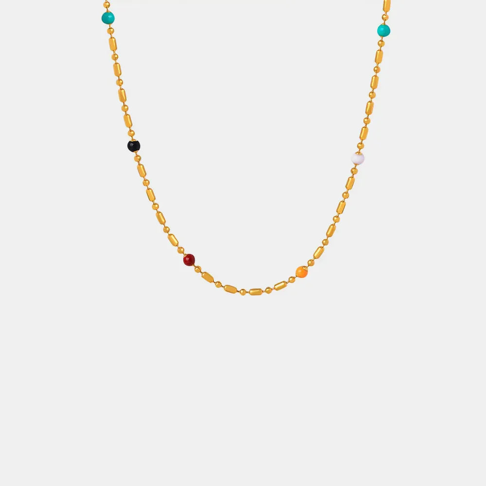 Gold necklace with colorful beads and elongated gold links