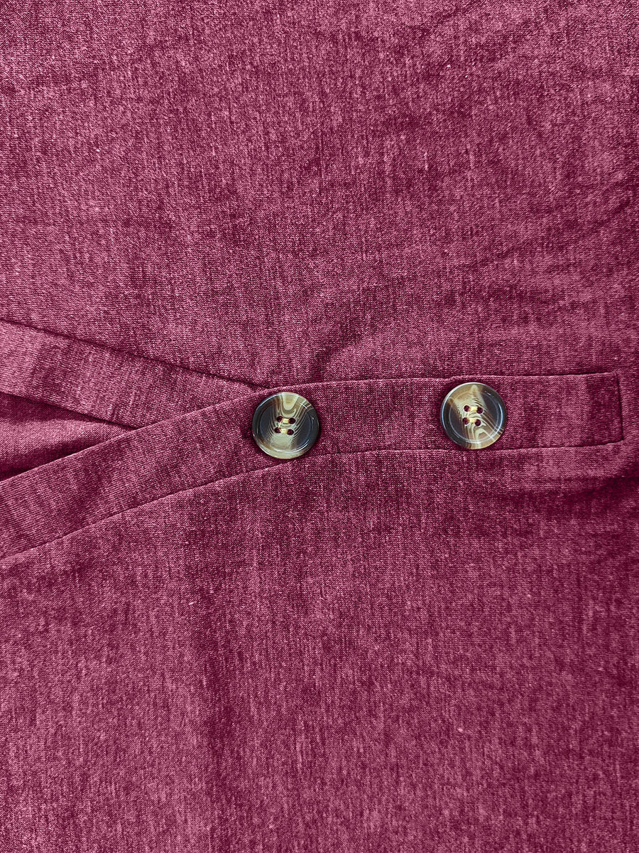 Buttoned Henley slouch tee in cerise with two decorative buttons and a crossover detail.