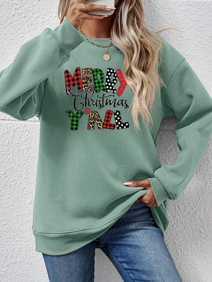 Sage green sweatshirt with Merry Christmas Y'all graphic in mixed prints like plaid and leopard