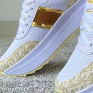 White round toe platform sneakers with beige logo print and gold stripe detail.