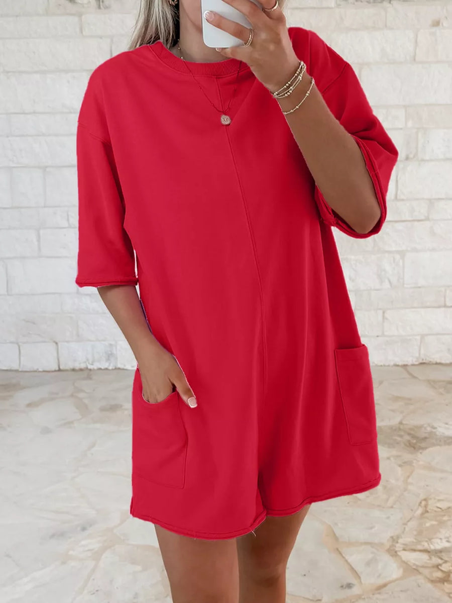 Scarlet cotton romper with half sleeves and two front pockets.