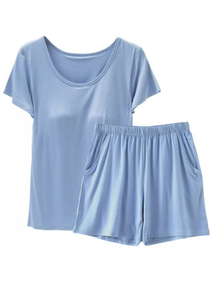 Light blue short sleeve pajama set with scoop neck top and elastic waist shorts with pockets.